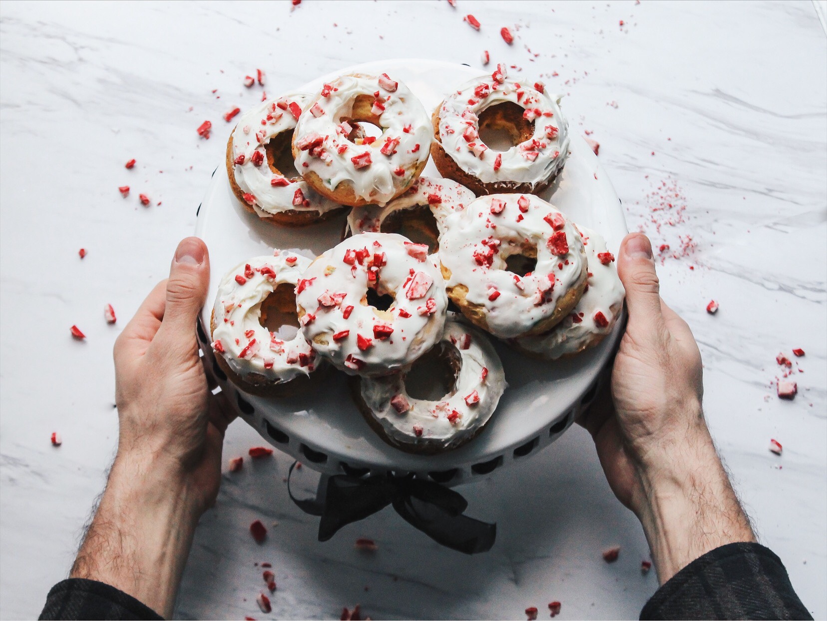 handing out tray of donuts